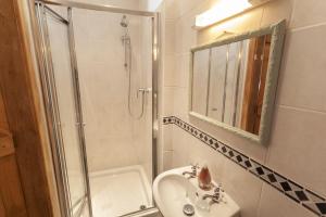 a bathroom with a shower and a sink and a mirror at The Mill House Bampton in Bampton +13 photos