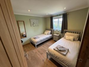 a small bedroom with two beds and a mirror at 1 Bed in Norwich oc-46293 in Brundall