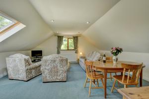 a living room with a table and chairs at Dunkery View Wootton Courtenay in Minehead