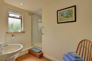 a bathroom with a tub and a sink and a shower at Dunkery View Wootton Courtenay in Minehead