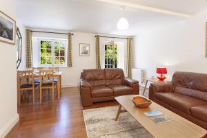 a living room with a couch and a table at Luccombe Cottage Luccombe in Luccombe