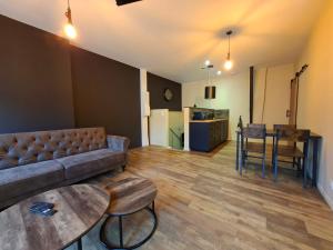 a living room with a couch and a table at Spa d'Assier in Feurs