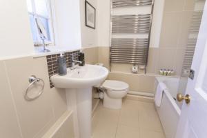 a bathroom with a sink and a toilet at Luccombe Cottage Luccombe in Luccombe +6 photos