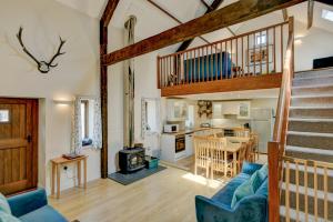 a living room with a staircase leading to a kitchen at Yenworthy Mill Countisbury in Countisbury
