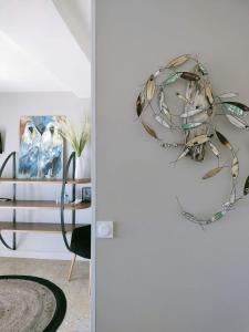 a glass artwork hanging on a wall in a room at La Stregheria in La Franqui-Plage