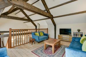 a living room with a blue couch and a table at Yenworthy Mill Countisbury in Countisbury