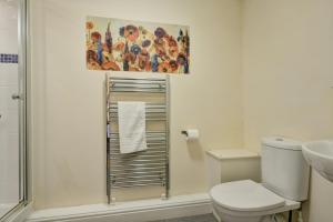 a bathroom with a toilet and a shower and a painting at Yenworthy Mill Countisbury in Countisbury +17 photos