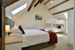 a bedroom with a large white bed in a attic at Yenworthy Mill Countisbury in Countisbury
