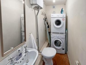 a bathroom with a washing machine and a sink at The Crows Nest Porlock Weir in Porlock