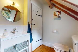 a bathroom with a sink and a mirror at Little Hanger Porlock in Porlock +32 photos
