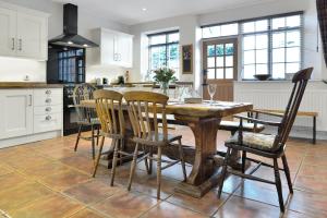 a kitchen with a wooden table and chairs at Bowness Porlock in Porlock