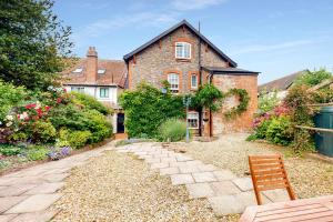 a brick house with a bench in front of it at Bowness Porlock in Porlock