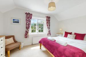 a bedroom with a large bed and a window at Bowness Porlock in Porlock