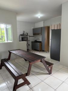a kitchen with a wooden table in a room at Apartamento Sabrina in Curitiba