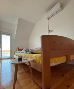 a bedroom with a bed and a small table at Blue River, sojenica na Dunavu in Belgrade
