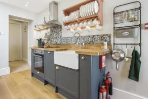 a kitchen with a sink and a stove at The Old Kitchen Exford in Exford