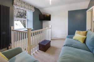 a living room with a couch and a window at The Old Kitchen Exford in Exford