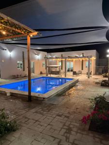 a swimming pool in a backyard at night at Los Agaves Lto in Loreto