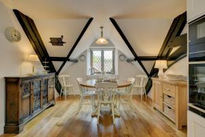 a kitchen with a table and chairs in a room at Two Grooms Cottage Dunster in Dunster