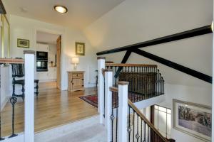 a living room with a staircase and a kitchen at Two Grooms Cottage Dunster in Dunster +20 photos
