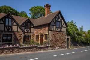 a house on the side of the road at Two Grooms Cottage Dunster in Dunster