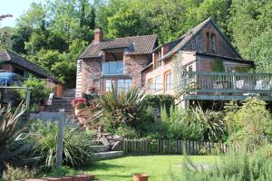 an old house with a garden in front of it at The Stable Block Porlock Weir in Porlock