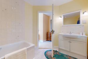a bathroom with a tub and a sink and a mirror at The Wool Barn Simonsbath in Exford +28 photos