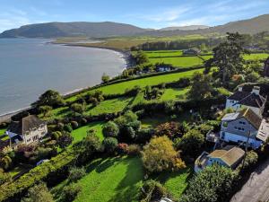 an aerial view of a house and the ocean at St Anthonys Cottage Porlock Weir in Porlock