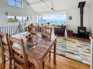 a dining room with a table and a fireplace at St Anthonys Cottage Porlock Weir in Porlock