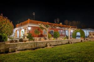 a brick house with lights on it at night at Finca el Placer in Ulldecona