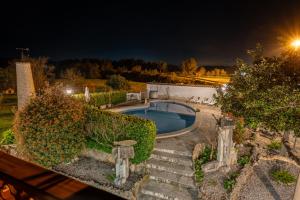 a swimming pool in a yard at night at Finca el Placer in Ulldecona