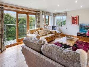 a living room with two couches and a table at Ormrods Withypool in Withypool
