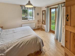 a bedroom with a bed and a window at Ormrods Withypool in Withypool