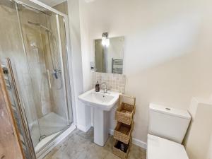 a bathroom with a sink and a shower and a toilet at Ormrods Withypool in Withypool +32 photos