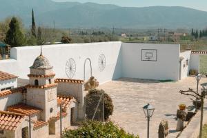a white building with a tower on top of it at Finca el Placer in Ulldecona +39 photos