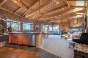 a kitchen and living room with wooden ceilings at Lighthouse in Little River