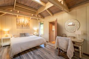 a bedroom with a large bed and a wooden ceiling at Lighthouse in Little River