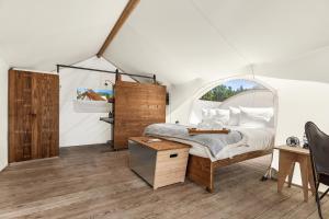a bedroom with a bed in a tent at Under Canvas Great Smoky Mountains in Pigeon Forge