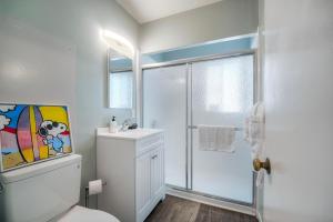 a white bathroom with a toilet and a shower at Oceanfront Apartment, Private Balcony, Beach Access, Sunset Views in Carlsbad