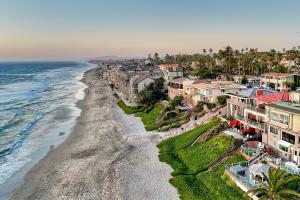 an aerial view of a beach and houses at Oceanfront Apartment, Private Balcony, Beach Access, Sunset Views in Carlsbad