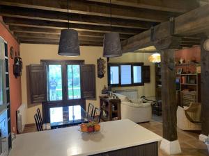 a kitchen and living room with a table with fruit on it at El Acebo de Tanarro in Sepúlveda