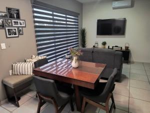 a living room with a table and a couch at Depa Colón in Mazatlán