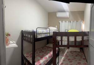 two bunk beds in a small room at Casa com ampla área externa de lazer in São Luís