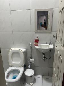 a small bathroom with a toilet and a sink at Casa com ampla área externa de lazer in São Luís +10 photos
