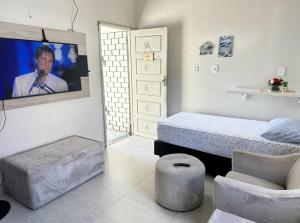 a bedroom with a bed and a tv on the wall at Casa com ampla área externa de lazer in São Luís