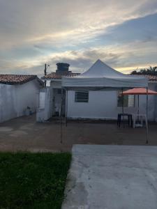 a white tent in front of a white house at Casa com ampla área externa de lazer in São Luís