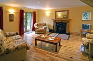 a living room with two couches and a fireplace at 2 Bed in Maam oc-i252 in Claggan