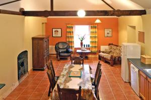 a living room with a table and a fireplace at 2 Bed in Maam oc-i252 in Claggan +7 photos