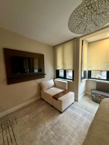 a living room with a couch and a flat screen tv at MEYS Apartment 2 in Istanbul