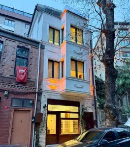 a white house with a car parked in front of it at MEYS Apartment 2 in Istanbul